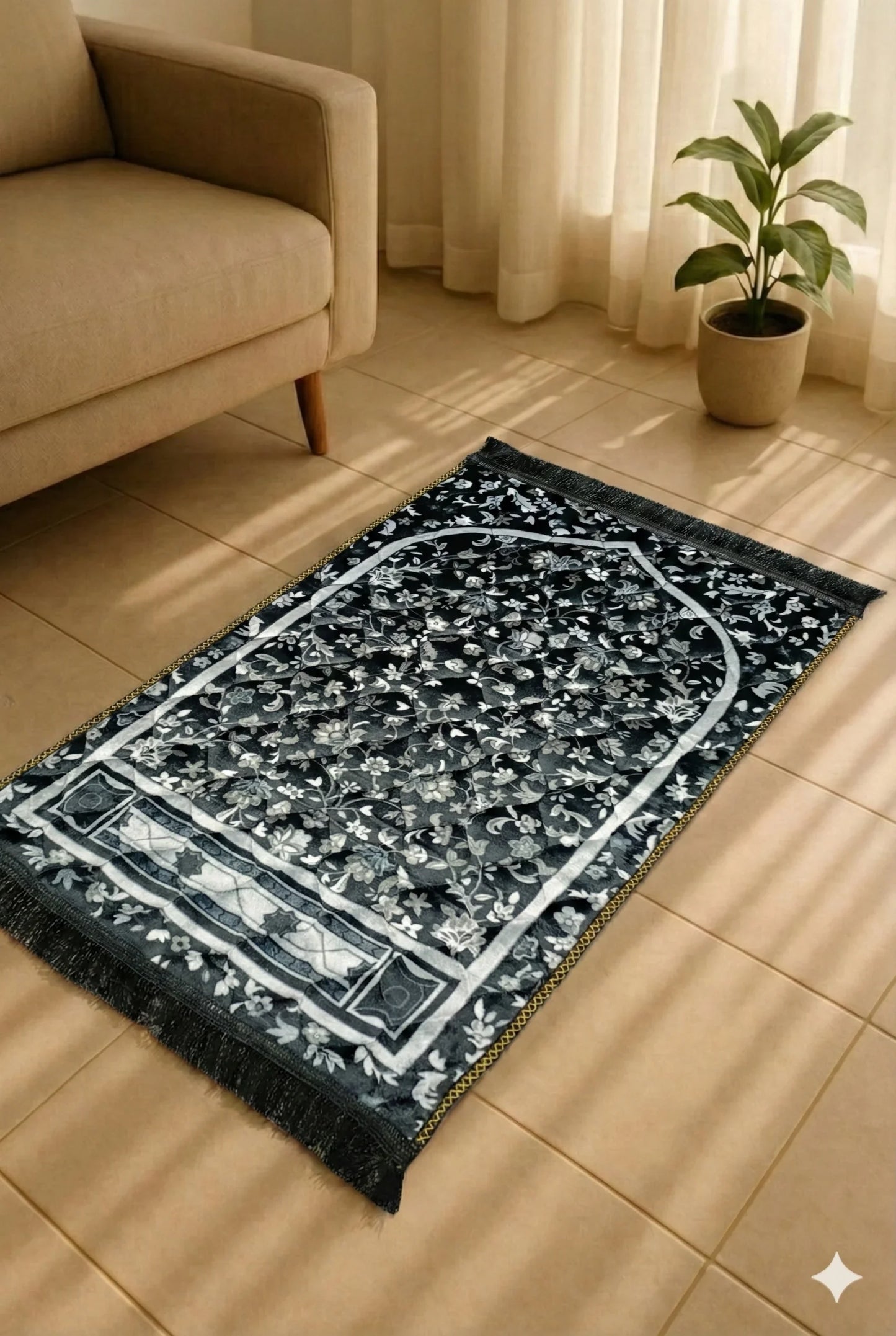 Black and white floral patterned Islamic prayer mat on beige tiled floor near beige sofa and potted plant